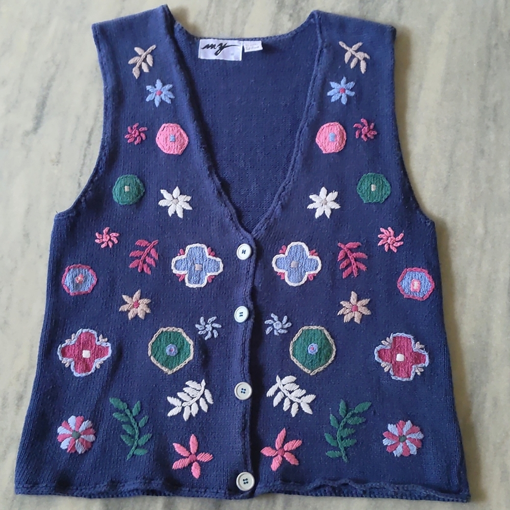 Woman's cotton blended sweater vest with embroidered flowers.